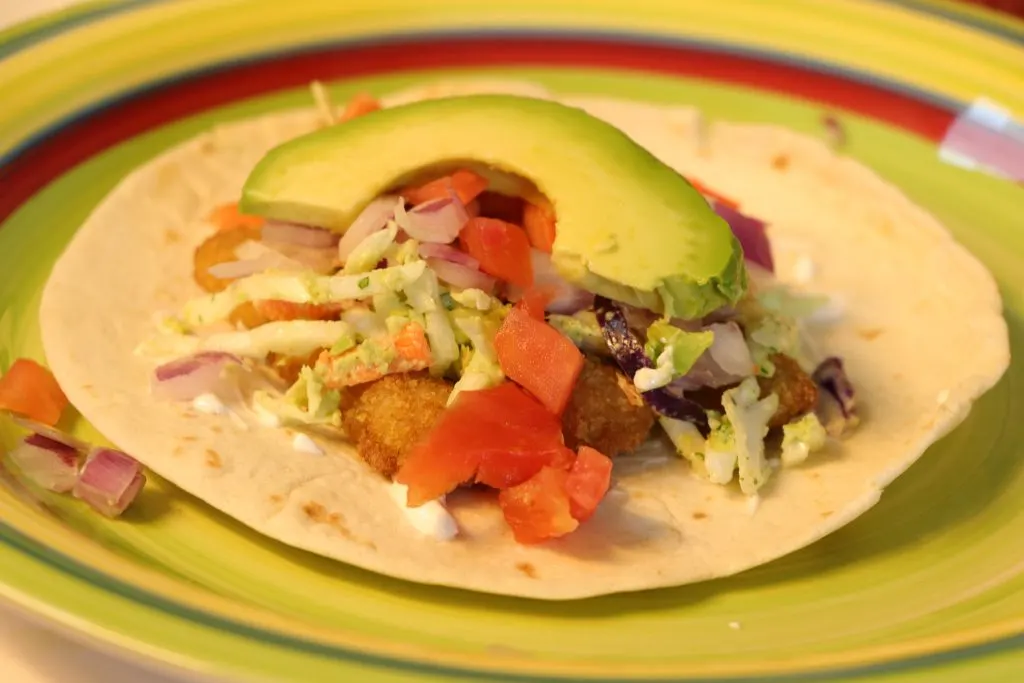 Fish taco with avocado and cilantro slaw