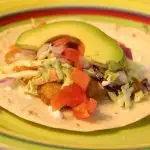 Fish taco with avocado and cilantro slaw