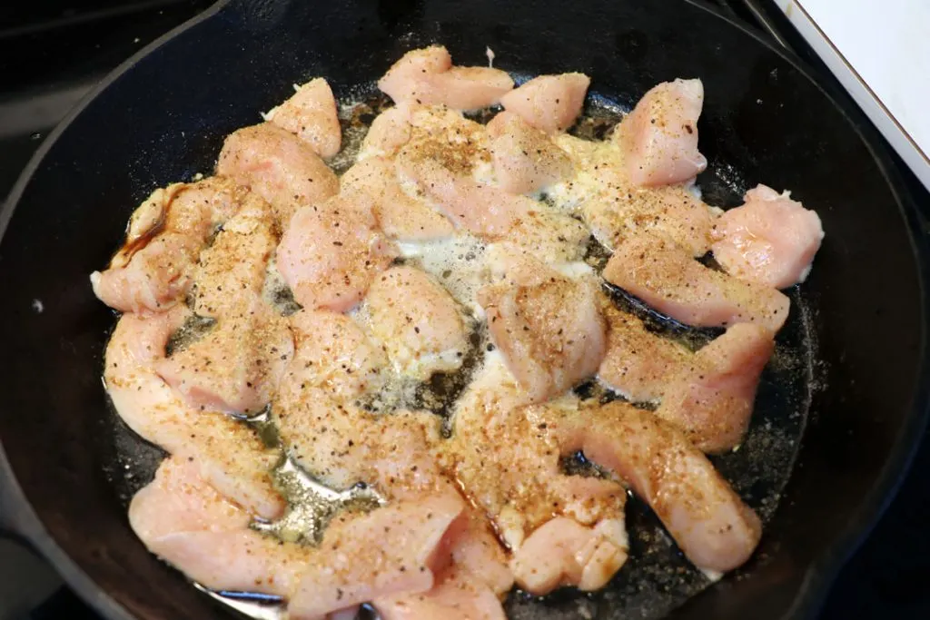 raw chicken cut up for a chicken philly bake