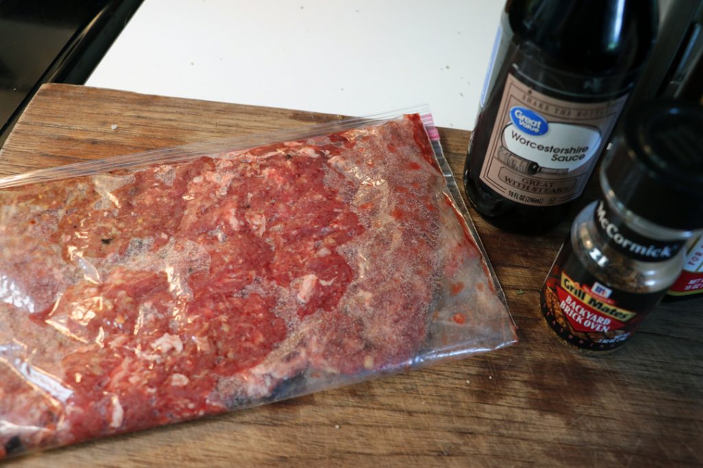 thin steak marinating in a bag