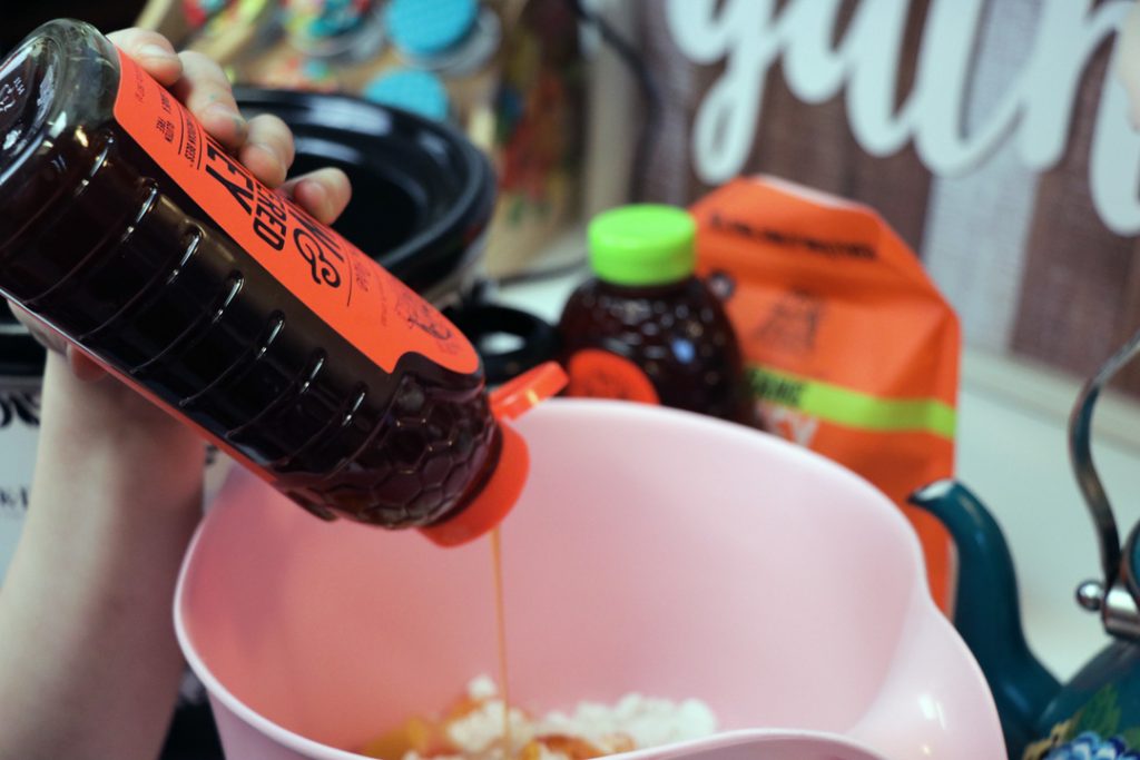 organic honey being poured in a bowl for cooking