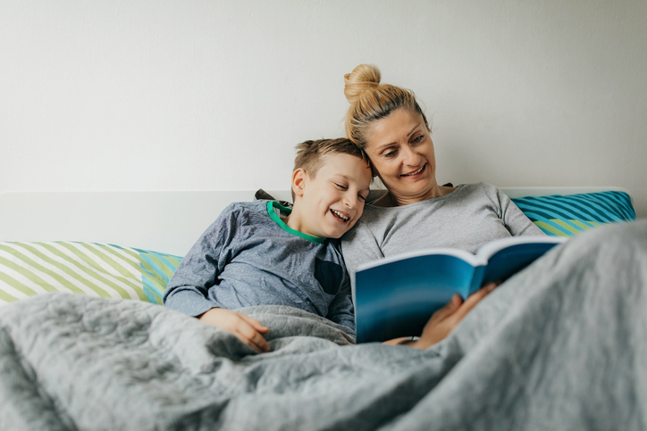 mother reading in bed with her son