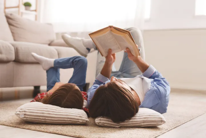 mom and daughter reading on the floor