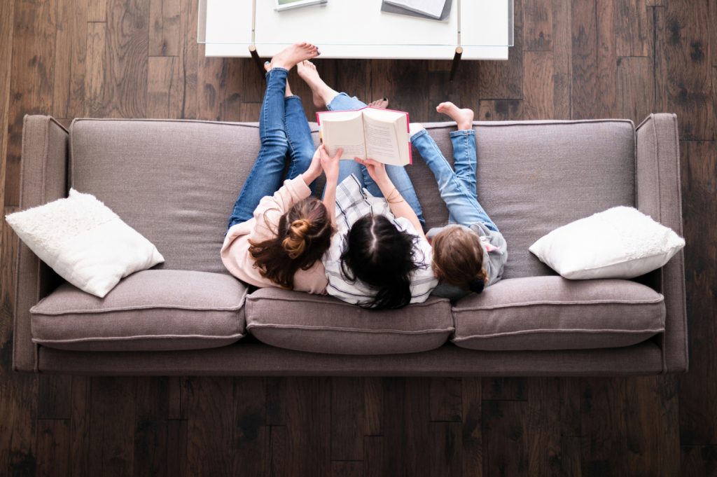 mom reading with kids on the couch