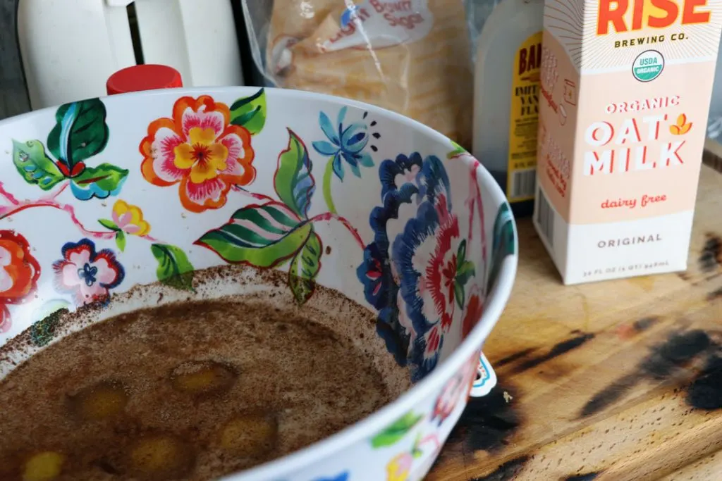 dairy free french toast batter in a pioneer woman bowl next to rise brewing co oat milk carton 