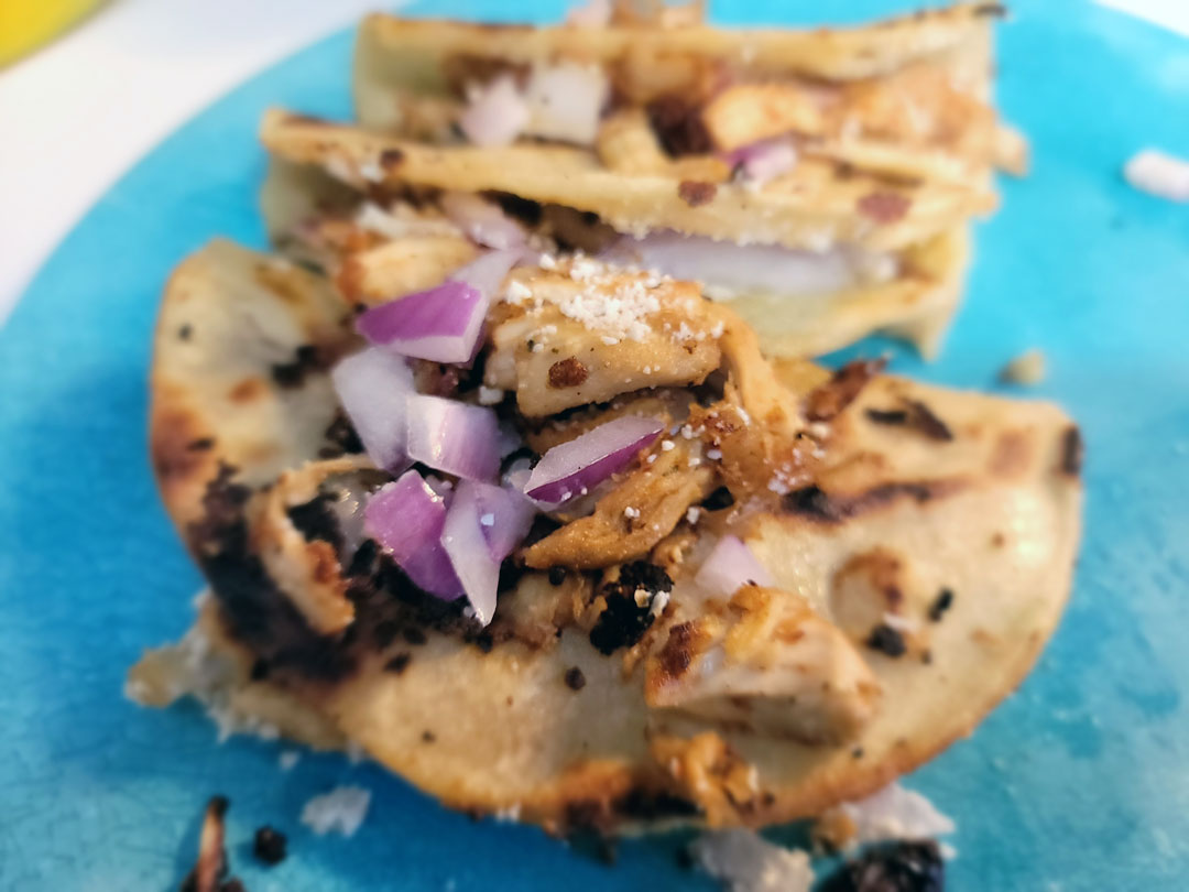 Fried Chicken Tacos with red onions and corn tortillas