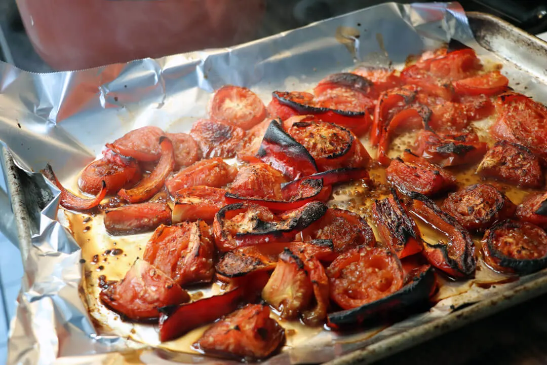 oven roasted tomatoes and peppers broiled on a pan