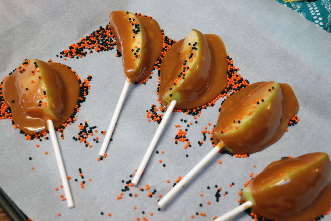 how to make caramel apple slices on a stick with caramel and sprinkles