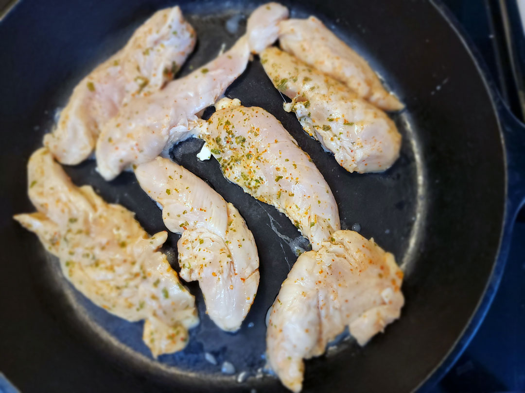 cast iron chicken tacos, chicken cooking in a cast iron pan