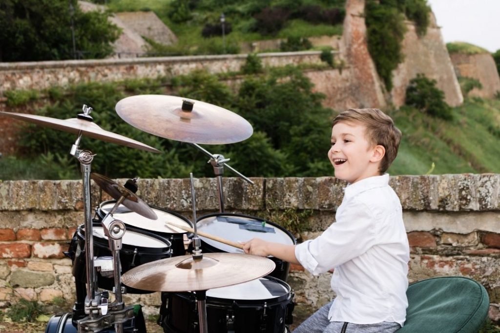 Teach your child how to hold the sticks correctly and make basic strokes on the drums