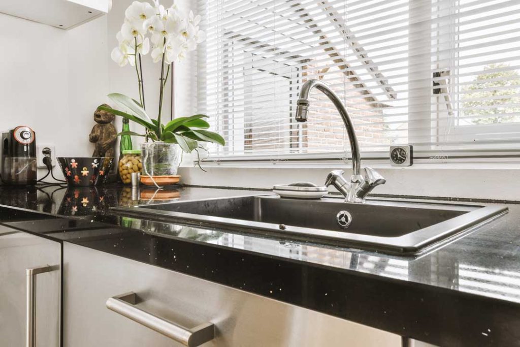 Garbage disposal installed under sink to manage kitchen food waste
