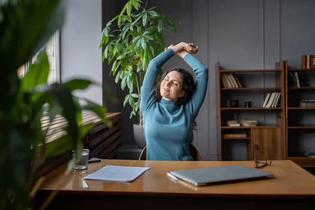 Woman showing signs of stress and fatigue while working late