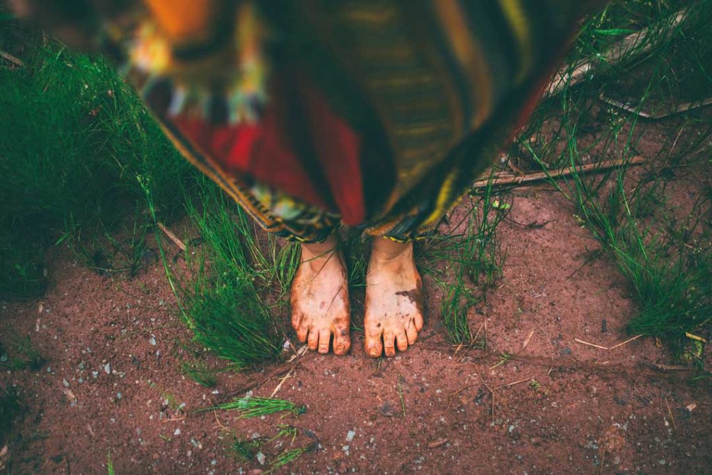 Barefoot walking in the grass for earthing benefits