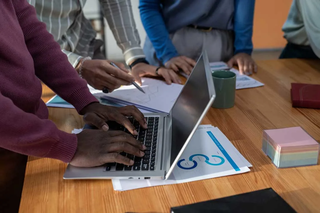 Business team planning new revenue streams at a laptop