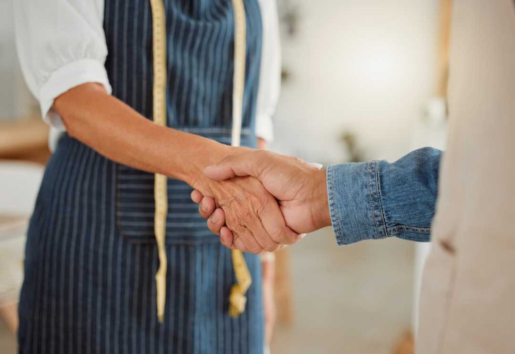 Customer shaking hands with a trusted local brand representative.