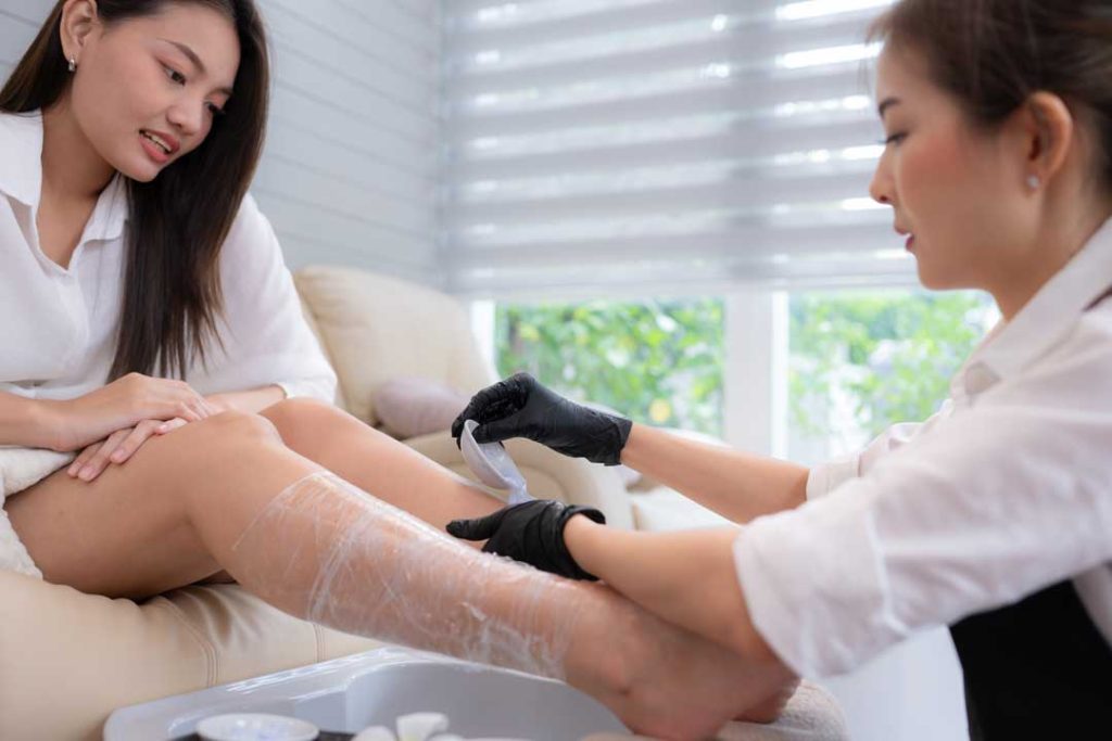 Discussing waxing preferences with esthetician