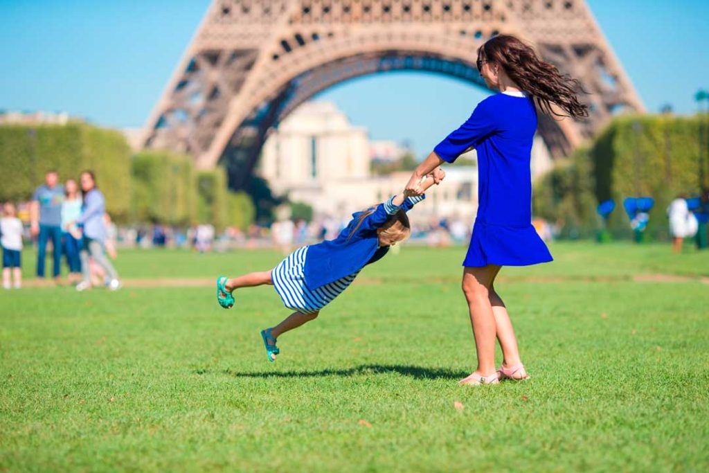 Family enjoying a picnic near Eiffel Tower in Paris.