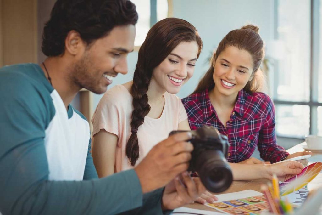 Family reviewing photos with a professional photographer.