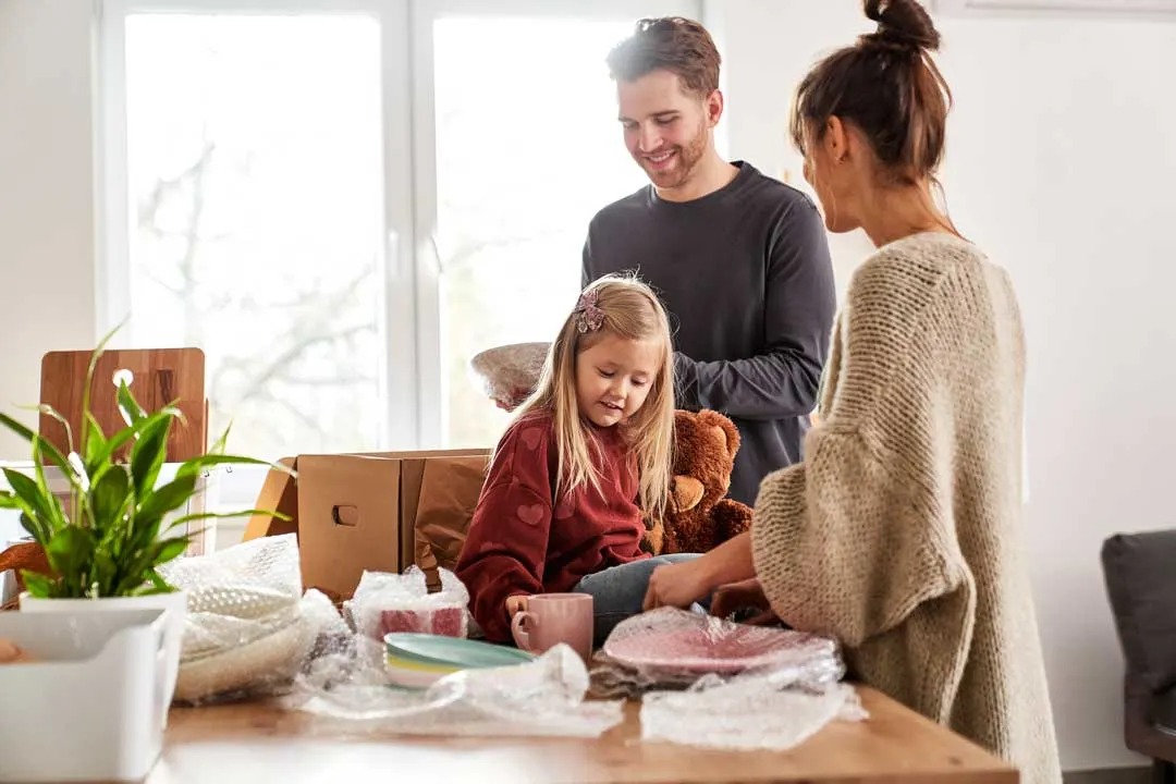 Family unpacking after moving into a new home