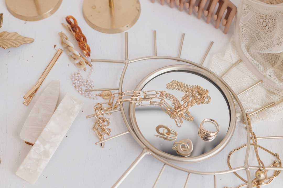 Flat lay of assorted jewelry styles for women how to style jewelry