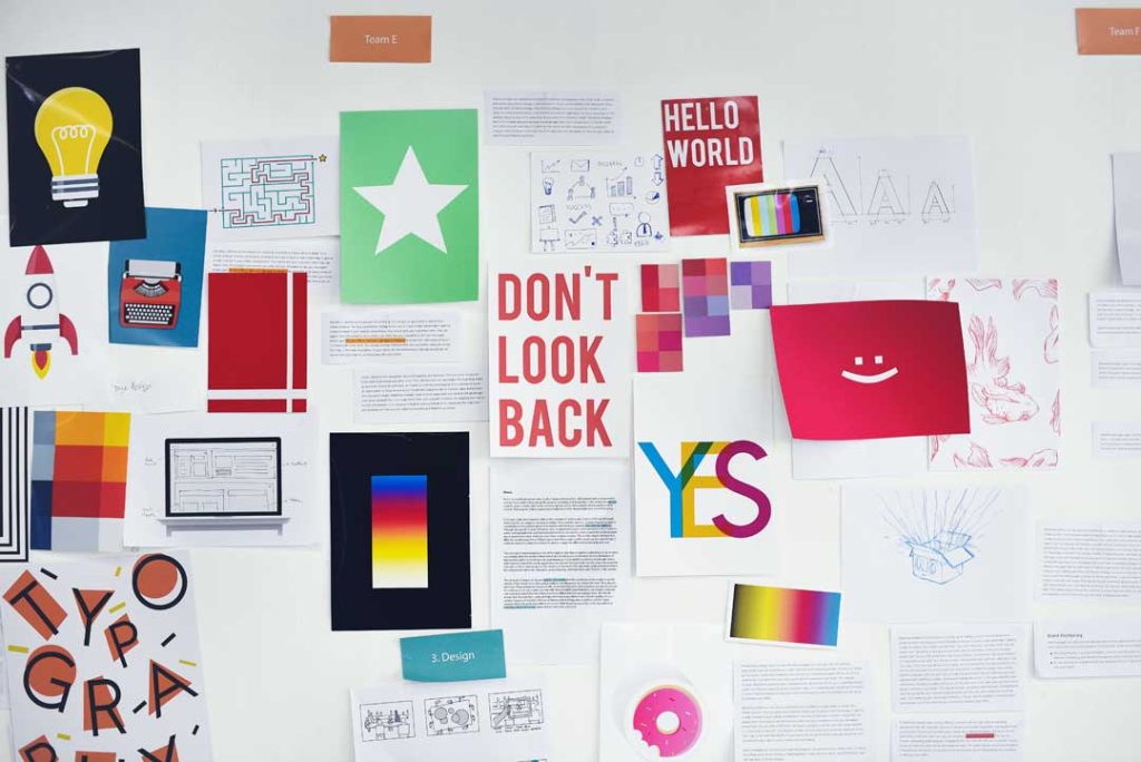 Flat lay of brand identity design elements including logo sketches and color swatches.
