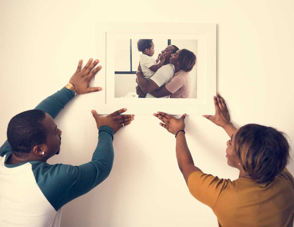 Framed family photography prints displayed at home.