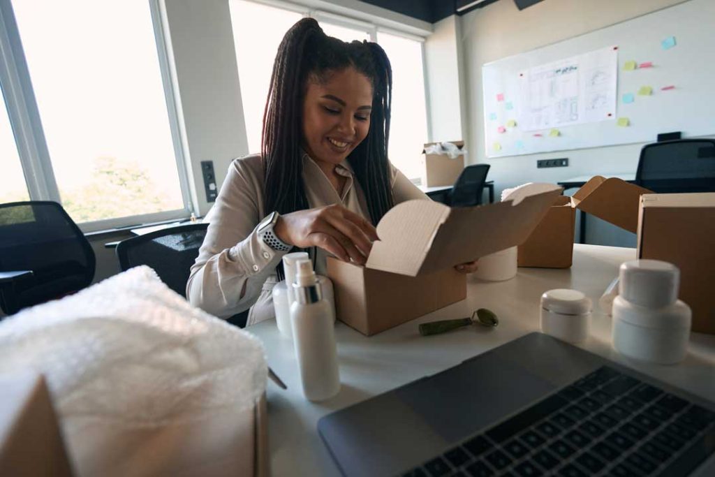 Happy customer emotionally engaged while unboxing a branded package.