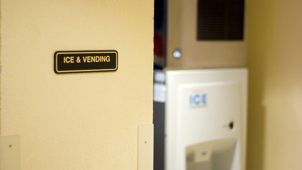 Staff performing regular maintenance on industrial ice maker