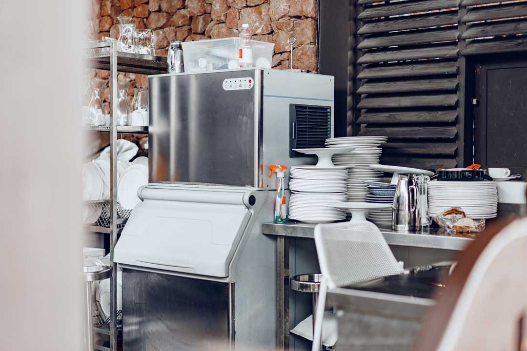 Commercial-grade industrial ice machine in restaurant kitchen