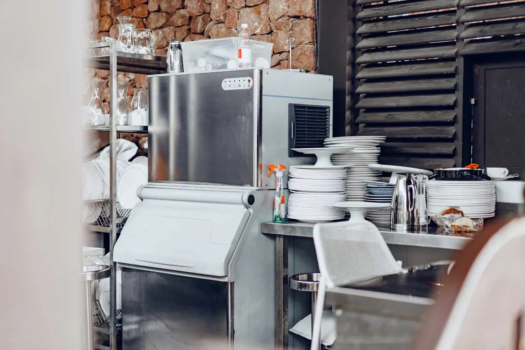 Commercial-grade industrial ice machine in restaurant kitchen