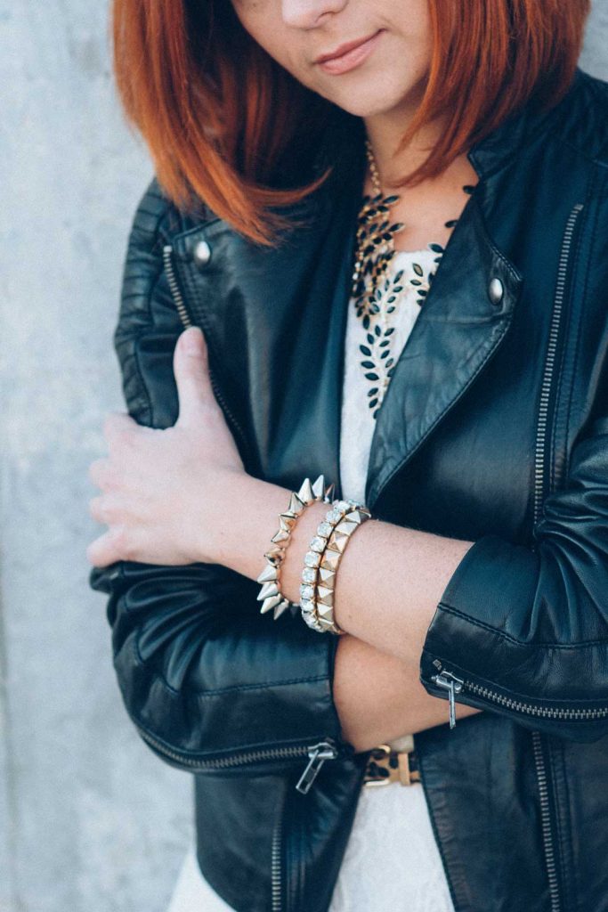 Layered necklaces and bracelets complementing minimalist style