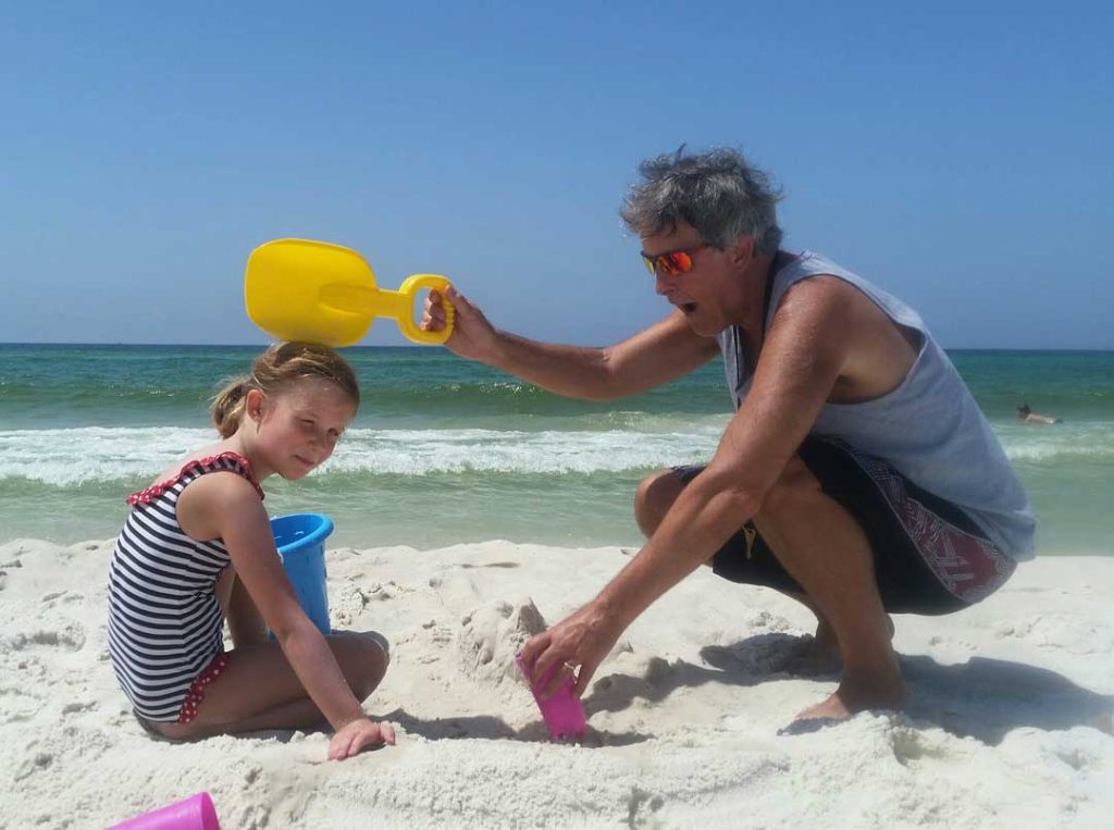 Kids building sandcastles on a 30A beach