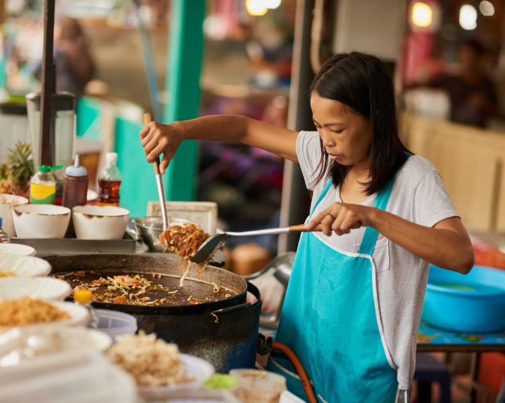 Local street food vendor preparing dishes