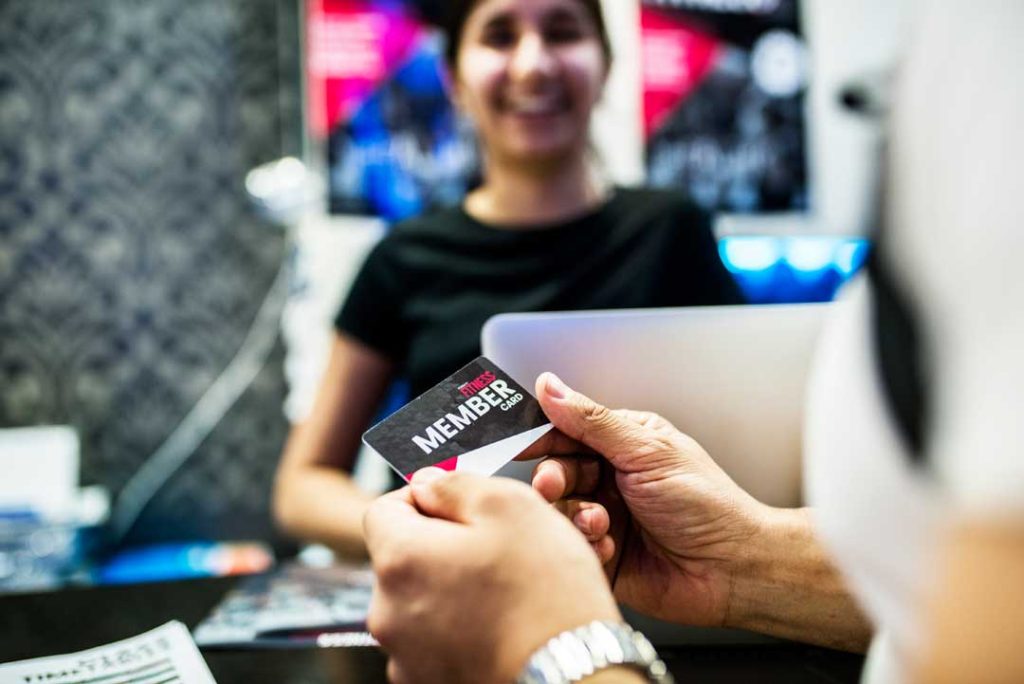 Loyal customers using reward cards at a recognizable store.
