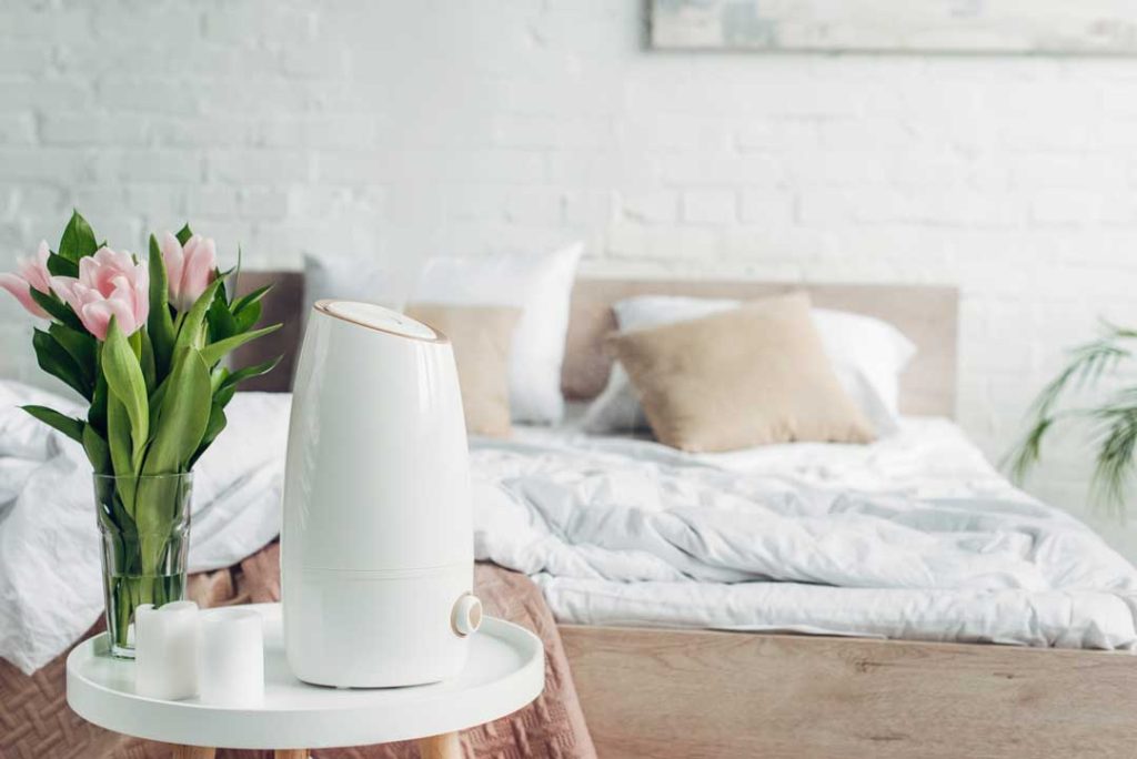 Modern dehumidifier in a clean bedroom