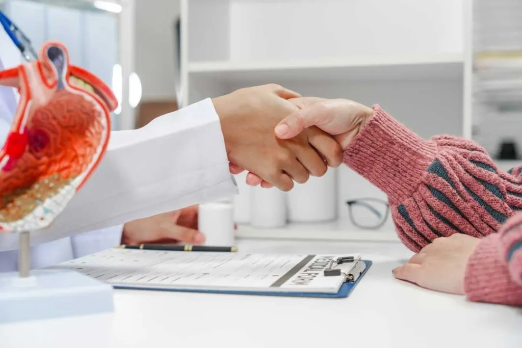 Patient shaking hands with a smiling cardiologist
