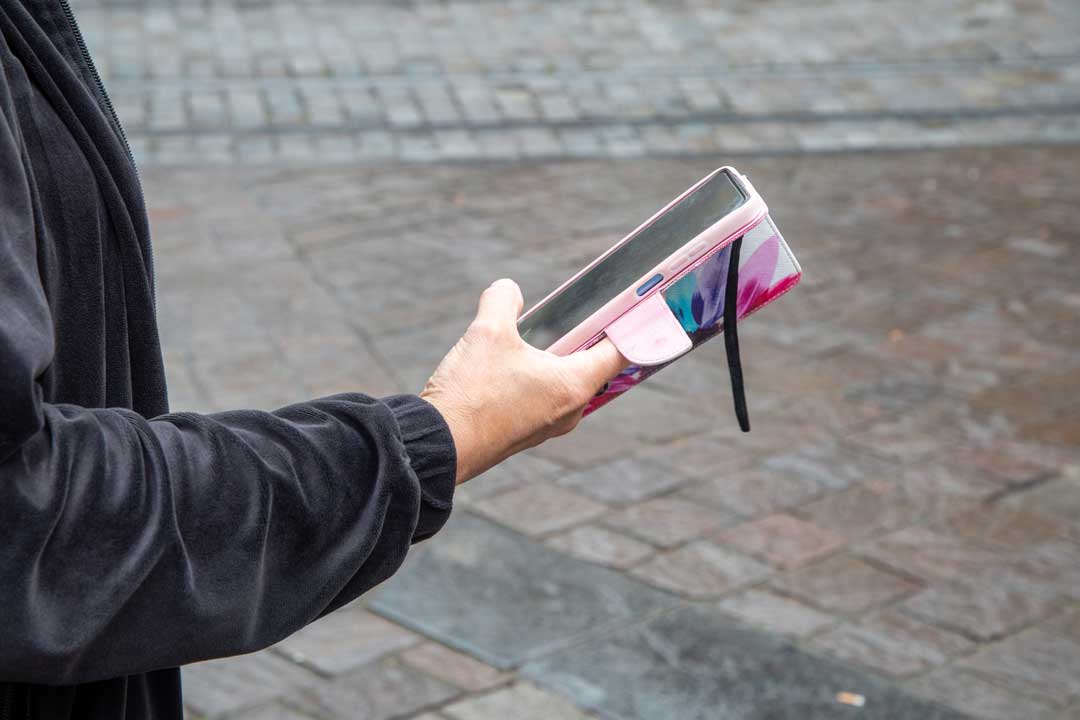 Person holding a phone with a stylish and protective phone case best phone case