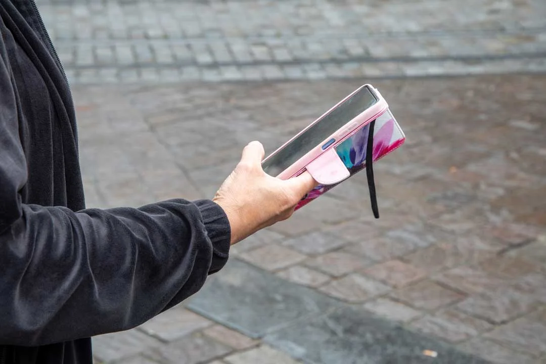 Person holding a phone with a stylish and protective phone case best phone case