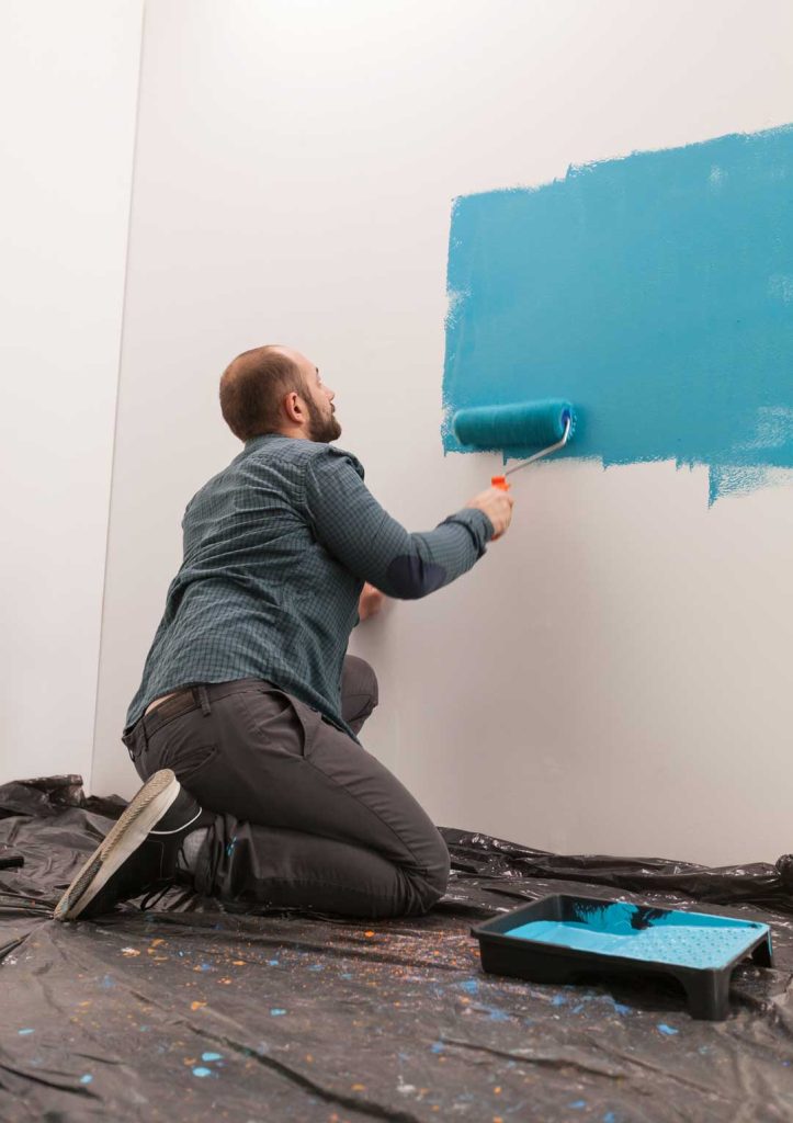 Person painting a wall a new fresh color