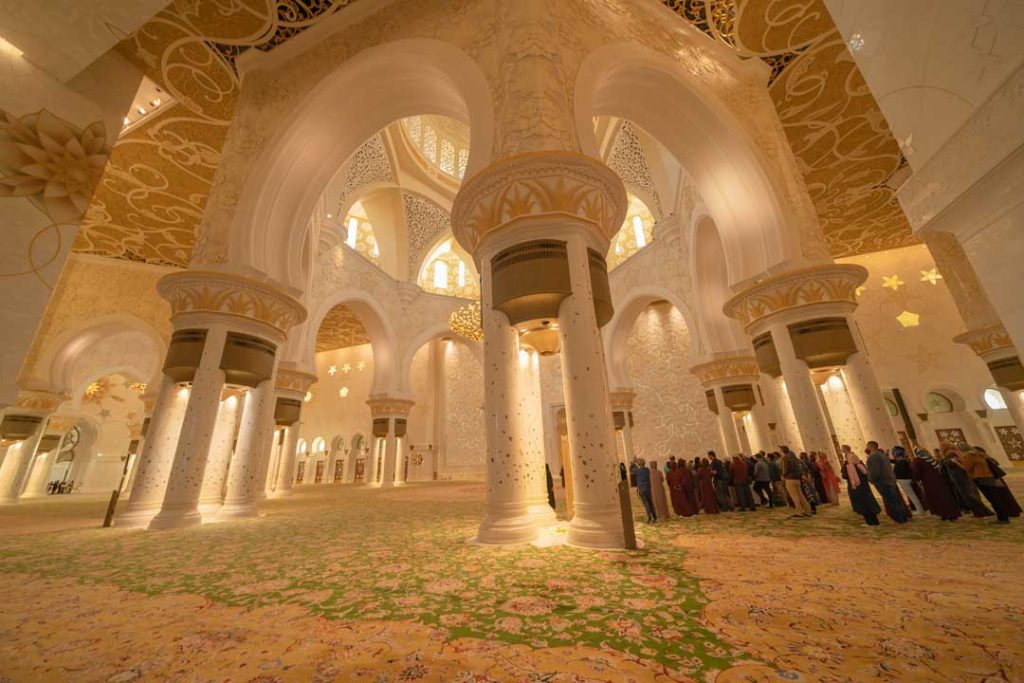 Guided tour group exploring Abu Dhabi's cultural sites from Dubai