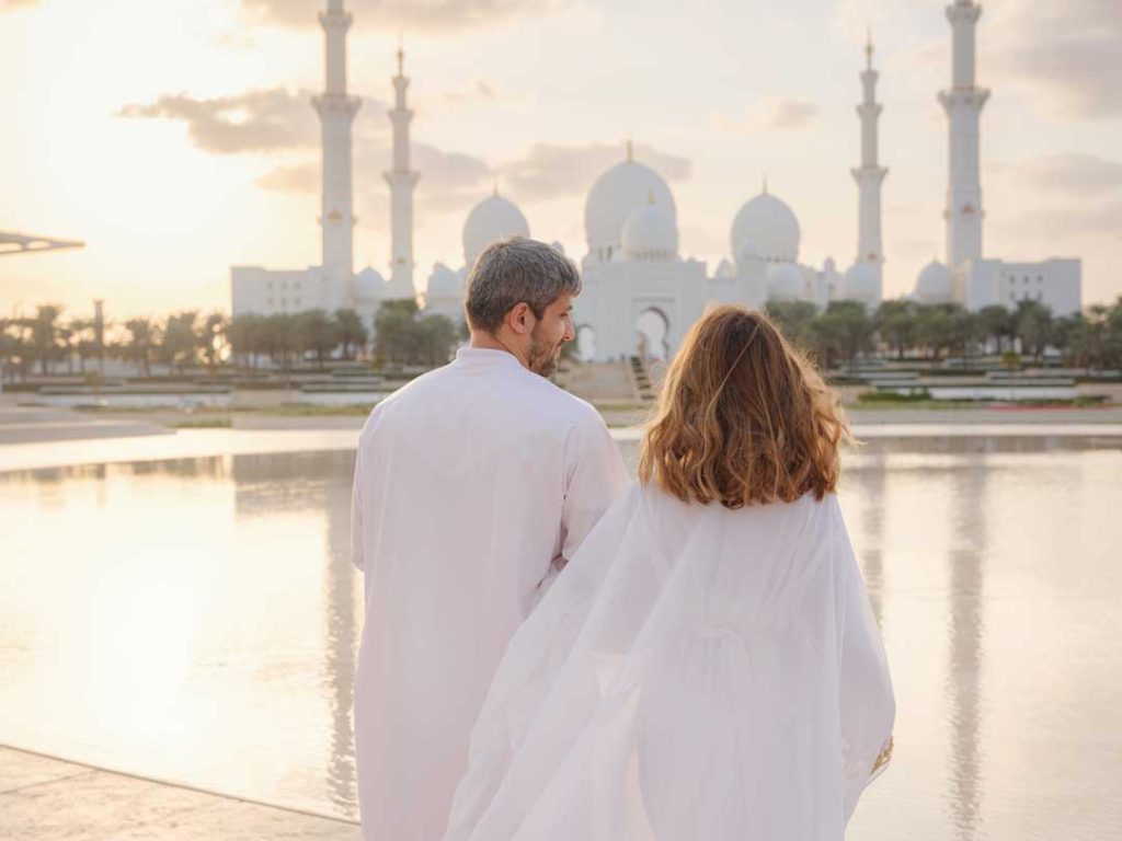 Visitors dressed conservatively near Sheikh Zayed Grand Mosque in Abu Dhabi
