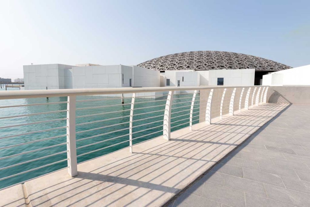Traveler admiring architectural landmarks in Abu Dhabi including the Louvre and Qasr Al Watan