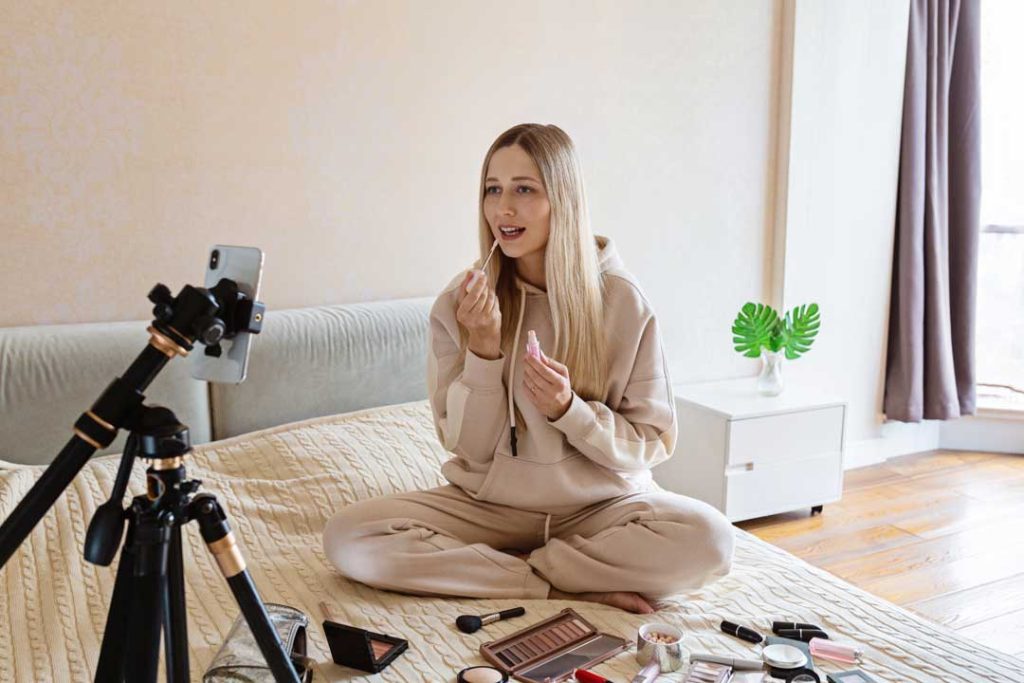 influencer recording a video with products