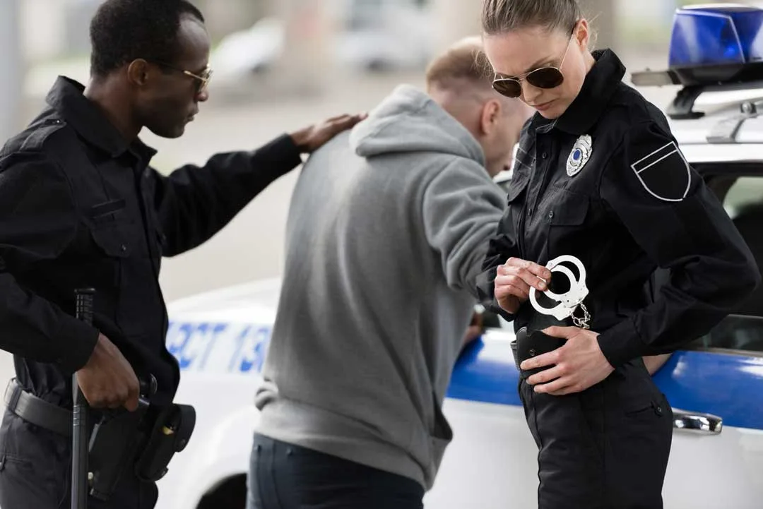 olice officer reading rights to a person in handcuffs