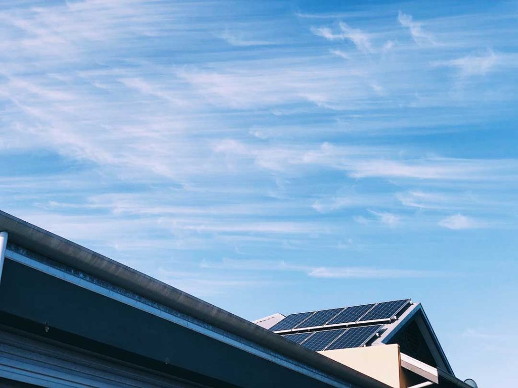 Sustainable roofing solutions with solar panels on a modern home.