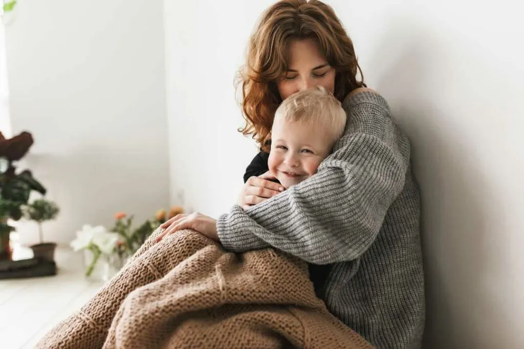 Mom cuddling her child for gentle wellness support.