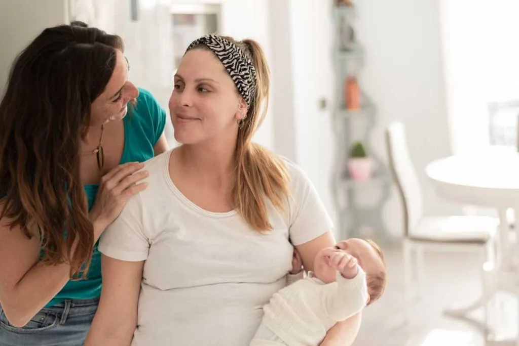 A supportive partner or family member tenderly comforting a new mother, emphasizing the emotional challenges and the need for support during postpartum recovery after a C-section