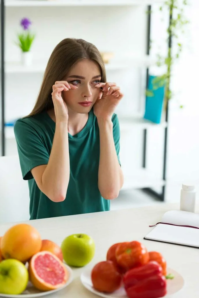 Woman applying biotin eyelash serum for lash health