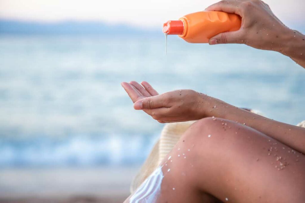  Applying sunscreen for UV skin protection in summer