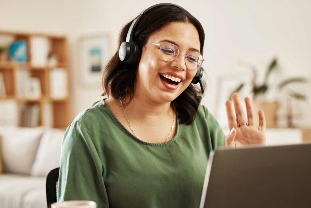 Woman on a video call, smiling with headset on